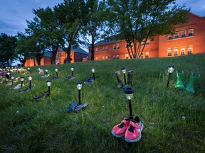 Pairs of children's shoes and toys are seen at memorial in front of the former Kamloops Indian Residential School after the remains of 215 children were found at the site in Kamloops, British Columbia.