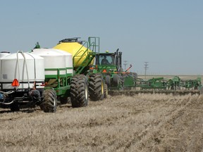 Farm equipment consists of the seeder, the seed container (yellow), followed by the liquid nitrogen tank and the last unit contains liquid phosphorous.