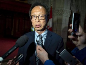 Sen. Yuen Pau Woo, leader of the Independent Senators Group, speaks to reporters on Parliament Hill in a file photo from June 19, 2018.
