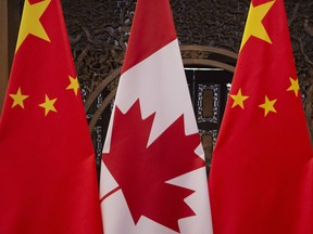 (FILES) In this file photo taken on December 5, 2017, shows Canadian and Chinese flags taken prior to a meeting with Canada's Prime Minister Justin Trudeau and China's President Xi Jinping at the Diaoyutai State Guesthouse in Beijing.