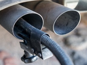 A measuring hose for emissions inspections in diesel engines sticks in the exhaust tube of a Volkswagen (VW) Golf 2,0 TDI diesel car at a garage in Frankfurt an der Oder, eastern Germany, on October 1, 2015. Volkswagen has admitted that up to 11 million diesel cars worldwide are fitted with devices that can switch on pollution controls when they detect the car is undergoing testing.