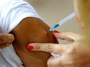 A patient receives a third dose of the Pfizer-BioNTech COVID-19 coronavirus vaccine at the outpatient clinics of the Cardiovascular Centre at Sheba Medical Center near Tel Aviv, Israel, on July 12, 2021.