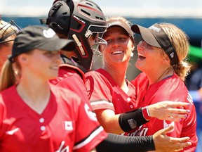 Canadian softball players celebrate after a win over Australia at the Tokyo Olympics on July 24, 2021.