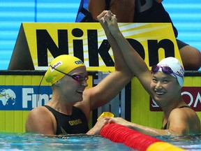 (L-R) Silver medalist Sarah Sjostrom of Sweden and gold medalist Margaret MacNeil of Canada celebrate after the Women's 100m Butterfly Final on day two of the Gwangju 2019 FINA World Championships at Nambu International Aquatics Centre on July 22, 2019 in Gwangju, South Korea.