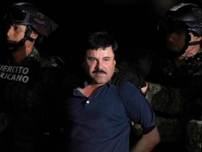 In this file photo taken on January 8, 2016, Mexican Drug kingpin Joaquin "El Chapo" Guzman is escorted into a helicopter at Mexico City's airport following his recapture during an intense military operation in Los Mochis, in Sinaloa State.