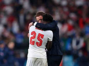 Bukayo Saka of England is consoled by Head Coach, Gareth Southgate after his penalty miss during the UEFA Euro 2020 Championship Final between Italy and England at Wembley Stadium on July 11, 2021 in London, England.