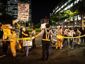 Protesters march outside of the Olympic village during a demonstration against the forthcoming Tokyo Olympic Games on July 16, 2021 in Tokyo, Japan. Protesters gathered to demonstrate against International Olympic Committee President Thomas Bach’s visit to Hiroshima amid concern over the safety of holding the Games during the global coronavirus pandemic.