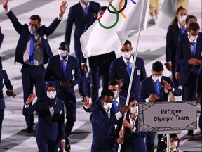 TOKYO, JAPAN - JULY 23: Flag bearers Yusra Mardini and Tachlowini Gabriyesos of The Refugee Olympic Team during the Opening Ceremony of the Tokyo 2020 Olympic Games at Olympic Stadium on July 23, 2021 in Tokyo, Japan.