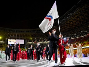 Flag bearers Sofya Velikaya and Maxim Mikhaylov of Team ROC lead their team in during the Opening Ceremony of the Tokyo 2020 Olympic Games at Olympic Stadium on July 23, 2021 in Tokyo, Japan.