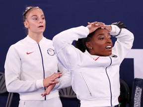 Grace McCallum and Simone Biles of Team United States react during the Women's Team Final on day four of the Tokyo 2020 Olympic Games at Ariake Gymnastics Centre on July 27, 2021 in Tokyo, Japan.