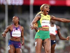 Elaine Thompson-Herah of Team Jamaica celebrates after winning the gold medal in the Women's 100m Final on day eight of the Tokyo 2020 Olympic Games at Olympic Stadium on July 31, 2021 in Tokyo, Japan. (Photo by Matthias Hangst/Getty Images)