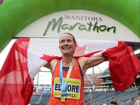 Malindi Elmore, who lives in Kelowna, B.C., shares as smile as she holds out a Canadian flag after winning the Women's Half Marathon National Championships at the Manitoba Marathon in Winnipeg, Man., on Sunday, June 16, 2019.