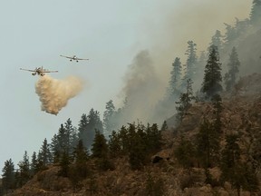 Water bombers douse part of the Nk'Mip Creek wildfire near Osoyoos, B.C., July 20, 2021.