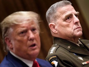 In this file photo taken on October 7, 2019, Chairman of the Joint Chiefs of Staff Army General Mark Milley (right) listens while U.S. President Donald Trump speaks before a meeting with senior military leaders in the Cabinet Room of the White House in Washington, DC.