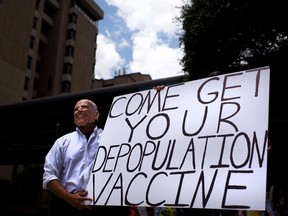An anti-vaccine protester dressed up as U.S. President Joe Biden holds a sign at a rally in Houston on June 26.