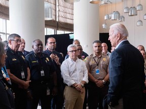 US President Joe Biden greets first responders to the collapse of the 12-story Champlain Towers South condo building in Surfside.