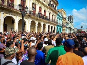 People take part in a demonstration against the government of Cuban President Miguel Diaz-Canel in Havana, on July 11, 2021. - Thousands of Cubans took part in rare protests Sunday against the communist government, marching through a town chanting "Down with the dictatorship" and "We want liberty."
