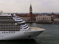 The MSC Orchestra cruise ship moves past the Bell Tower and the Doge's Palace in Venice's Piazza San Marco.
