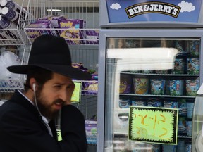 An ultra-Orthodox Jewish man walks by Ben and Jerry's ice cream in Jerusalem on July 20.