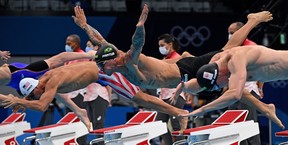 USA's Michael Andrew (L), Brazil's Bruno Fratus (C) and Netherlands' Thom de Boer (R) dive to start in a heat for the men's 50m freestyle swimming event during the Tokyo 2020 Olympic Games at the Tokyo Aquatics Centre in Tokyo on July 30, 2021. (Photo by Oli SCARFF / AFP) (Photo by OLI SCARFF/AFP via Getty Images)