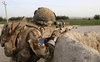 A sniper provides cover with an L115A3 rifle as a British Paratrooper patrol crosses open ground operating in the Upper Sangin Valley, Afghanistan in 2008.