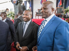 Minister of Foreign Affairs and Worship Claude Joseph (L) and Minister of Planning and External Cooperation Simon Dieusel Desras (R) during a ceremony at La Primature in Port-au-Prince, Haiti, on July 20, 2021.