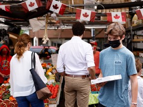 Canada's Prime Minister Justin Trudeau's son Xavier holds a pie while visiting a farmers' market with his family on Canada Day in Ottawa, Ontario, Canada July 1, 2021.