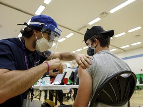 An adolescent receives a dose of the Pfizer-BioNTech COVID-19 vaccine at a clinic in Toronto on Wednesday, May 19, 2021.
