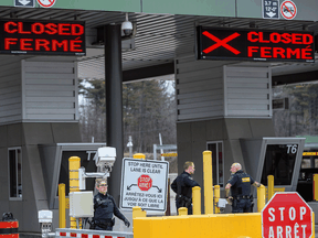 CBSA officers at the U.S.-Canada border crossing in Lansdowne, Ontario after it was announced that the border would close to "non-essential traffic" to combat the spread of COVID-19, March 19, 2020.