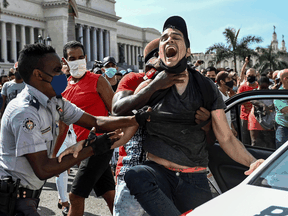 A protester is arrested during a demonstration against the government of Cuban President Miguel Diaz-Canel in Havana, on July 11, 2021.