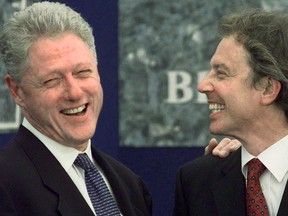 U.S. President Bill Clinton (left) is introduced by British Prime Minister Tony Blair during a ground-breaking ceremony for Springvale Educational Village in Belfast, Northern Ireland in 1998.