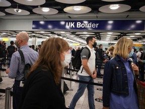 Arriving passengers queue at UK Border Control at the Terminal 5 at Heathrow Airport in London.