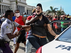 A man is arrested during a demonstration against the government of Cuban President Miguel Diaz-Canel in Havana, on July 11, 2021.