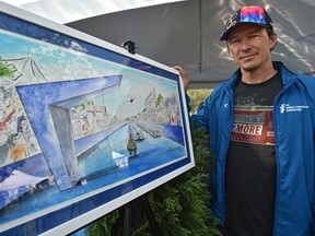 Simon Whitfield, retired Olympic triathlon champion, poses next to an artist rendering at the ITU World Triathlon, of the world triathlon championships in 2020 at Hawrelak Park in Edmonton, July 27, 2018.