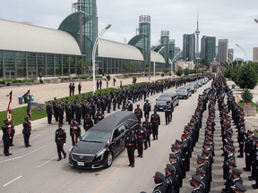 The hearse carrying the casket of Toronto Police officer Jeffrey Northrup arrives for his funeral in Toronto, on Monday July 12, 2021.