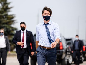 Prime Minister Justin Trudeau arrives with rolled-up shirt sleeves for a press conference at a construction site in Brampton, Ont., on July 19, 2021. The fact that voters seem be over COVID could affect his chances at the polls, writes Tasha Kheiriddin.