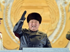 This picture taken on January 14, 2021 and released from North Korea's official Korean Central News Agency (KCNA) on January 15 shows North Korean leader Kim Jong Un gesturing from the tribune during a military parade celebrating the 8th Congress of the Workers' Party of Korea (WPK) in Pyongyang.