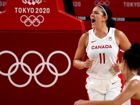 Natalie Achonwa of Canada celebrates after scoring a basket in Olympic action.