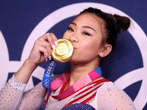 Gold medallist Sunisa Lee of the United States kisses her medal.
