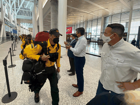 Ontario Natural Resources and Forestry Minister Greg Rickford, right, welcomes Mexican fire crews at Pearson Airport on Sunday, July 18, 2021.