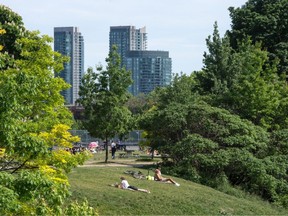 People lie on the grass in Toronto's Trinity Bellwoods Park, on Wednesday June 2, 2021.