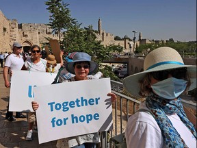Israeli women take part in a rally calling for an end to the Israeli-Palestinian conflict, along Jerusalem's Old City walls, on May 19, 2021.