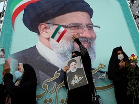A supporter of Ebrahim Raisi displays his portrait during a celebratory rally for his presidential election victory in Tehran, Iran, on June 19, 2021. Just 48.8 per cent of Iranians went to the polls to choose their preferred candidate from a slate of four handpicked by the regime.