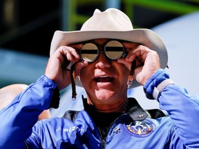 Billionaire American businessman Jeff Bezos wears goggles owned by Amelia Earhart which he carried into space at a post-launch press conference after he flew on Blue Origin's inaugural flight to the edge of space, in the nearby town of Van Horn, Texas, U.S. July 20, 2021.