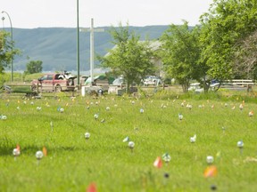 Flags mark where ground-penetrating radar recorded hits of what are believed to be 751 unmarked graves in this cemetery near the grounds of the former Marieval Indian Residential School on the Cowessess First Nation, Sask.