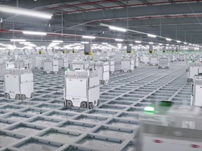 An Ocado 'hive' scuttle around the grid in a video by the company.