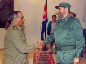 Ruben Martinez Puente seen shaking hands with Fidel Castro.