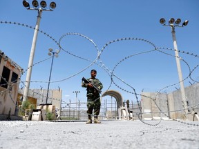 An Afghan National Army soldier stands guard at the gate of Bagram U.S. air base, on the day the last of American troops vacated it, Parwan province, Afghanistan July 2, 2021.