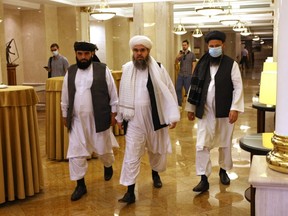 Leaders of the Taliban movement and negotiators Abdul Latif Mansoor (R), Shahabuddin Delawar (C) and Suhail Shaheen (L) walk to attend a press conference in Moscow on July 9, 2021.
