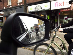 Cyclists ride on the designated Bloor Street bike lanes in Toronto on Thursday, October 12, 2017.